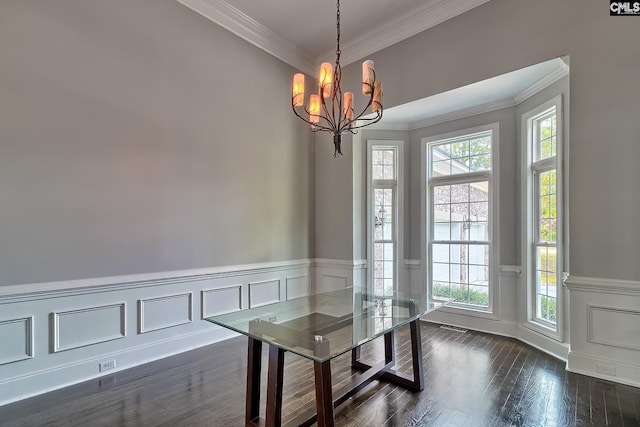 unfurnished dining area featuring a notable chandelier, ornamental molding, plenty of natural light, and dark hardwood / wood-style floors