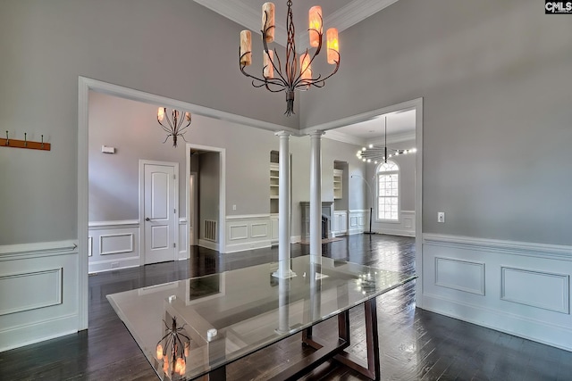 dining room with ornamental molding, decorative columns, a chandelier, and dark hardwood / wood-style flooring