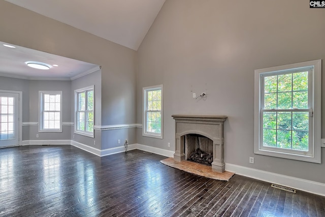 unfurnished living room with high vaulted ceiling, ornamental molding, a wealth of natural light, and dark hardwood / wood-style flooring