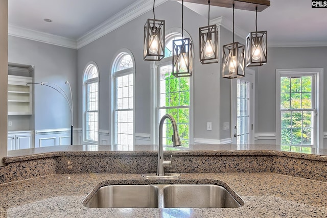 kitchen with crown molding, a healthy amount of sunlight, and sink