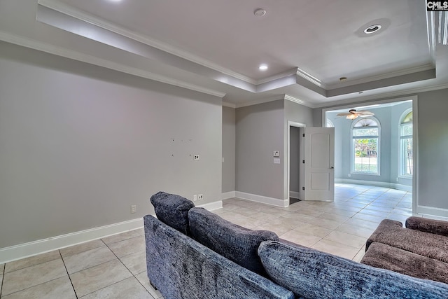 tiled living room with crown molding, a tray ceiling, and ceiling fan