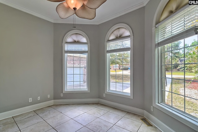 empty room with crown molding and light tile patterned flooring