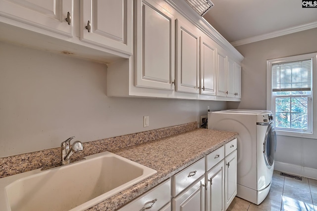 clothes washing area featuring washer / dryer, light tile patterned flooring, sink, crown molding, and cabinets