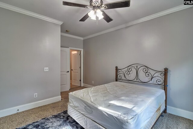 carpeted bedroom with ornamental molding and ceiling fan