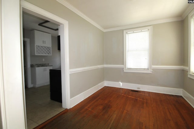 spare room featuring ornamental molding and wood-type flooring