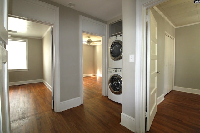 laundry room with ornamental molding, stacked washer / drying machine, and dark hardwood / wood-style flooring