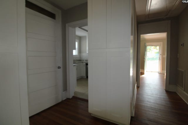 corridor with dark hardwood / wood-style flooring