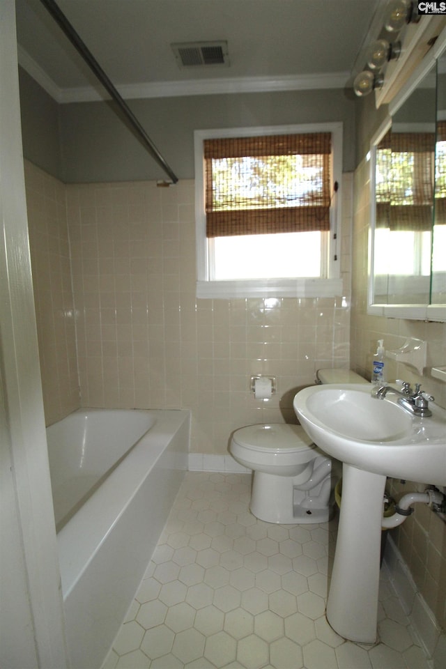 bathroom with bathing tub / shower combination, toilet, and tile patterned flooring