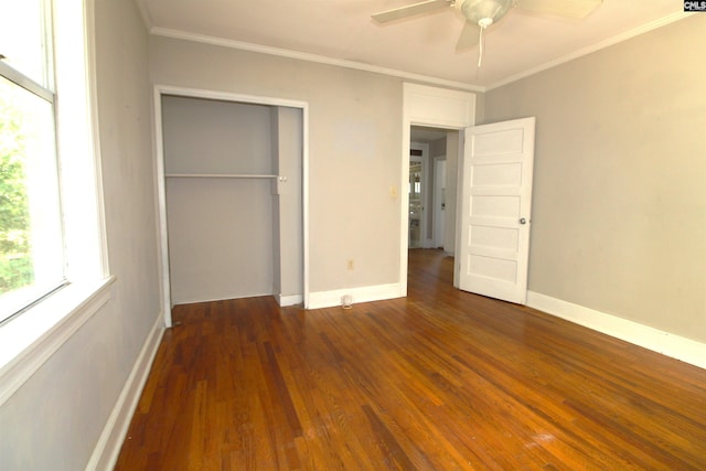 unfurnished bedroom with a closet, ornamental molding, ceiling fan, and dark hardwood / wood-style flooring