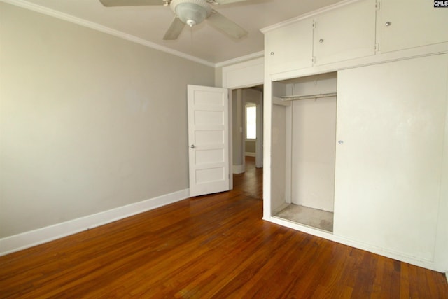 unfurnished bedroom featuring a closet, ornamental molding, ceiling fan, and dark hardwood / wood-style flooring