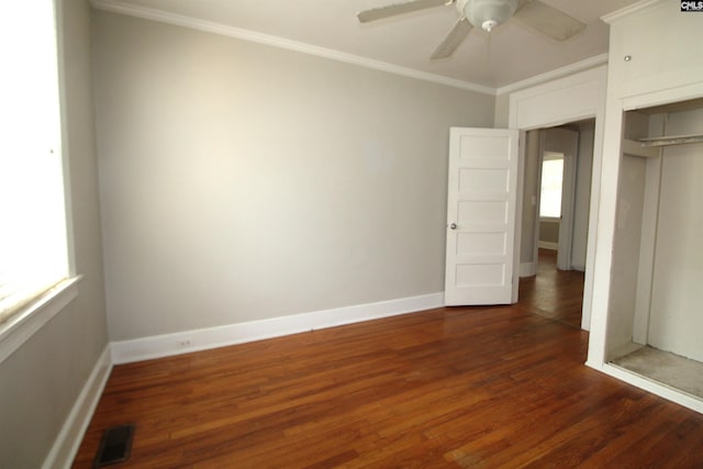 unfurnished bedroom featuring dark wood-type flooring, crown molding, and ceiling fan