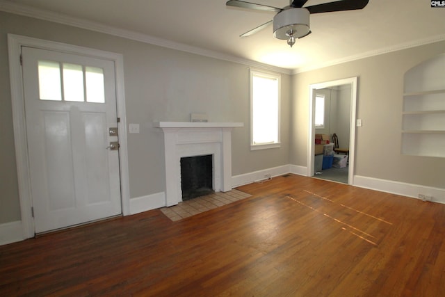 unfurnished living room featuring built in shelves, ornamental molding, wood-type flooring, and ceiling fan