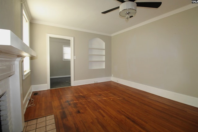 unfurnished living room featuring ornamental molding, wood-type flooring, built in features, and ceiling fan