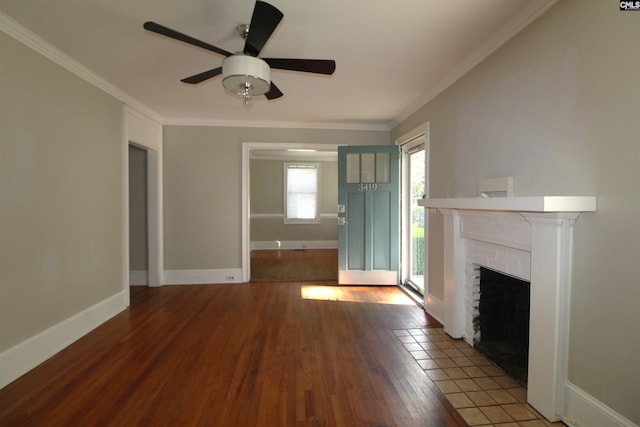 unfurnished living room featuring ceiling fan, crown molding, a brick fireplace, and hardwood / wood-style floors