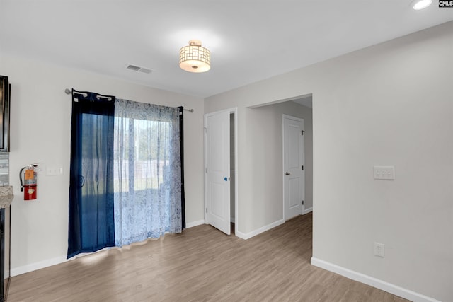 unfurnished room with light hardwood / wood-style flooring