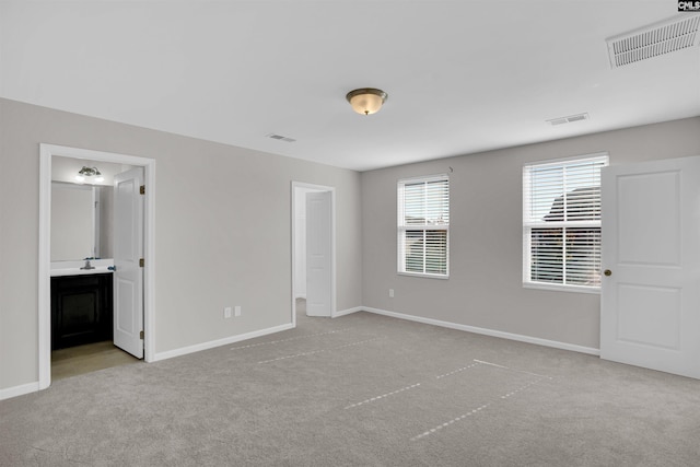 unfurnished bedroom featuring visible vents, carpet, and baseboards