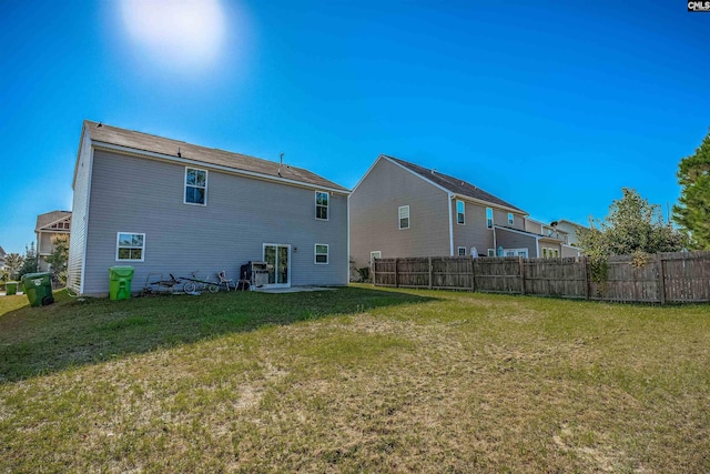 rear view of property with a yard and a patio