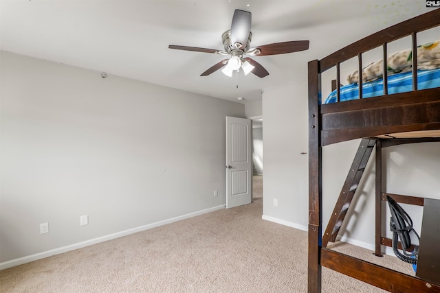 unfurnished bedroom featuring light colored carpet and ceiling fan