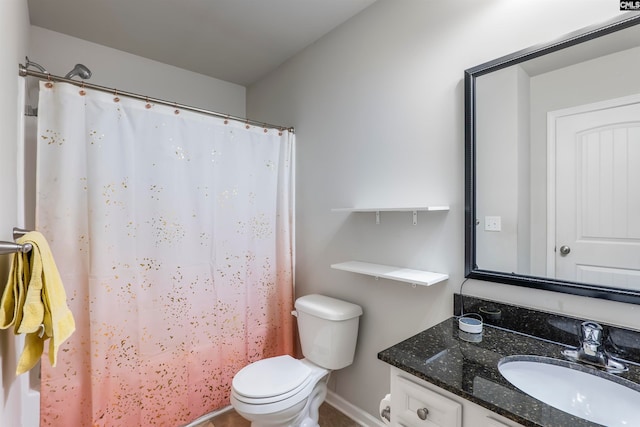 bathroom featuring vanity, toilet, and curtained shower