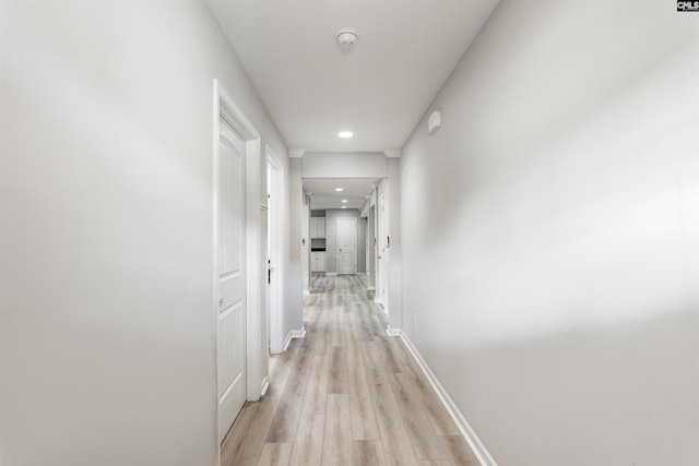 corridor with light wood-type flooring