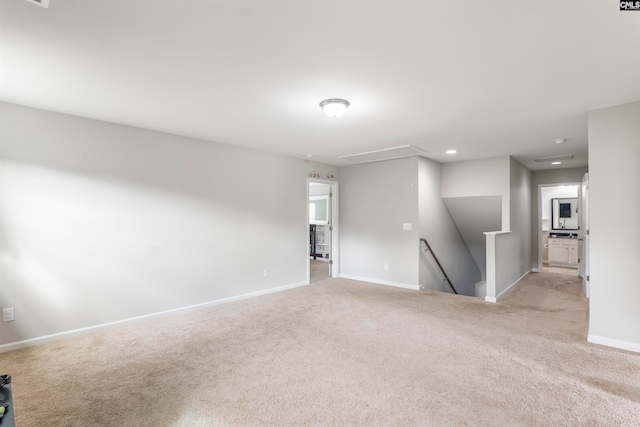 unfurnished room featuring light carpet