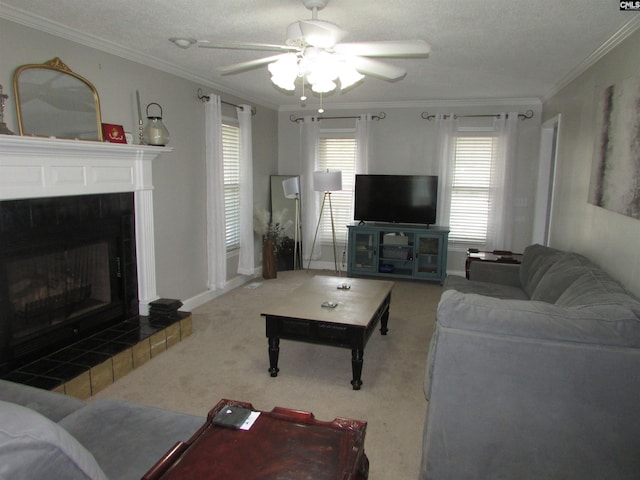 carpeted living room with ornamental molding, a textured ceiling, a fireplace, and ceiling fan