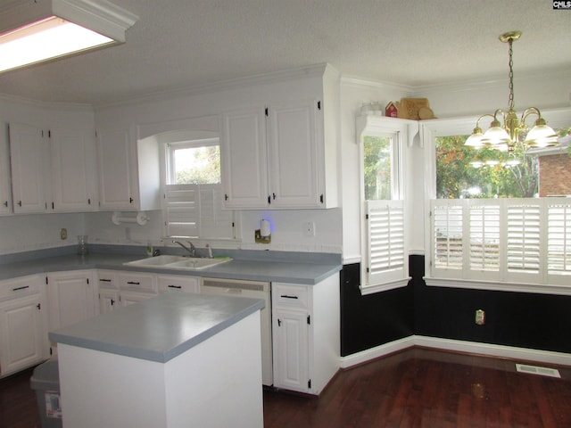 kitchen with white cabinetry, sink, a kitchen island, and dark hardwood / wood-style flooring