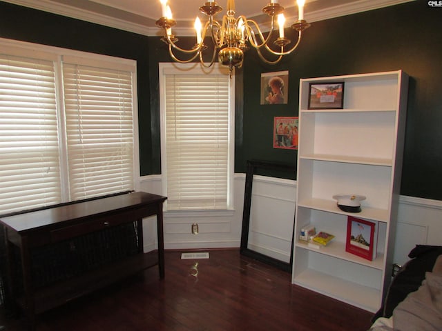 interior space with crown molding, a notable chandelier, and dark hardwood / wood-style flooring