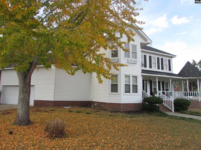 view of front facade with a garage and a porch