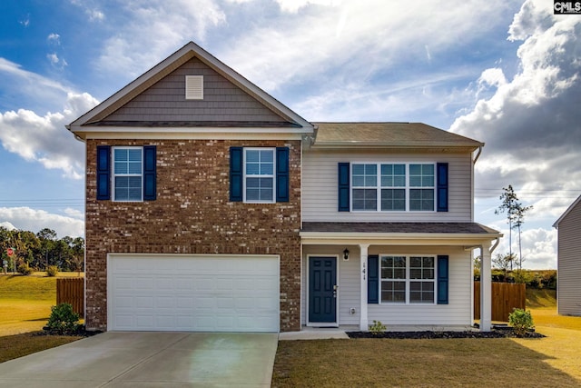 view of front of property with a front lawn and a garage