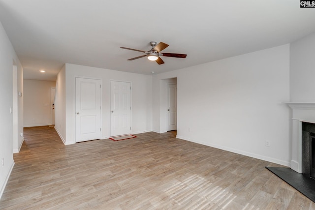 unfurnished living room with light wood-type flooring and ceiling fan