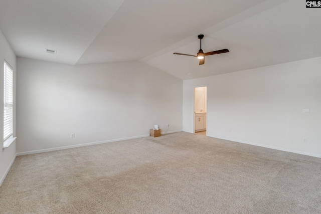 spare room with lofted ceiling, light carpet, and ceiling fan