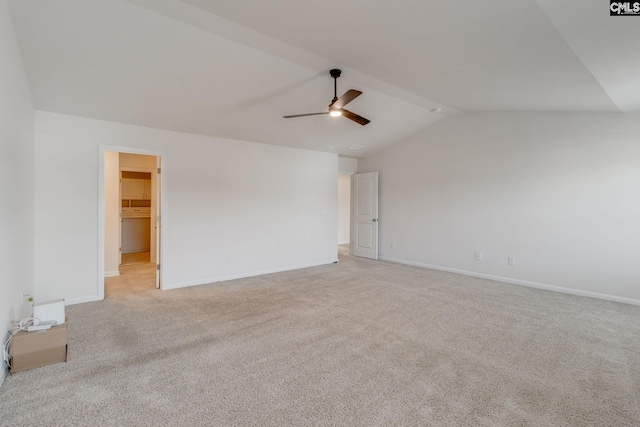 carpeted empty room featuring ceiling fan and vaulted ceiling