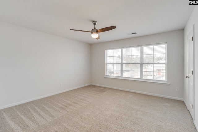 spare room with light colored carpet and ceiling fan