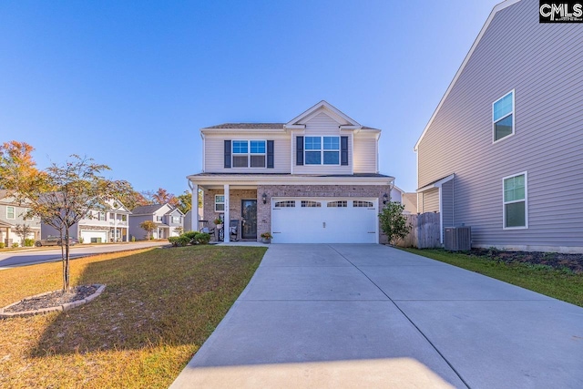 view of front of home with a front lawn, central AC unit, and a garage