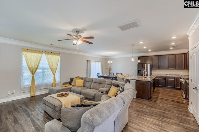 living room featuring ceiling fan, ornamental molding, dark hardwood / wood-style flooring, and plenty of natural light