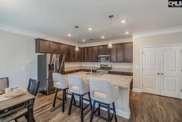 kitchen with pendant lighting, crown molding, dark wood-type flooring, and stainless steel appliances