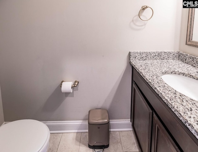 bathroom with vanity, toilet, and tile patterned flooring