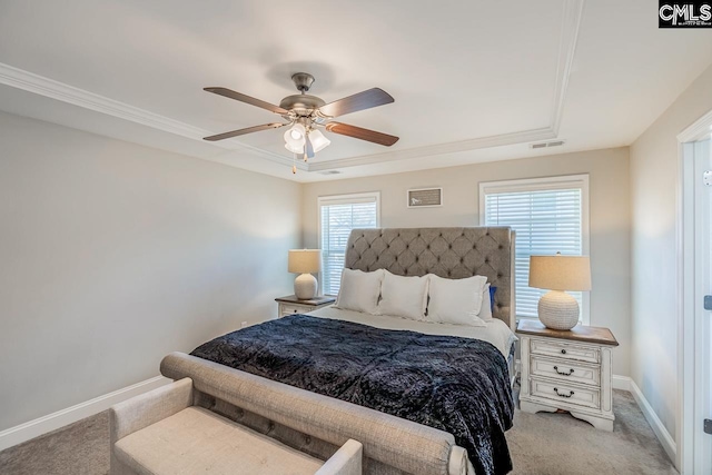 carpeted bedroom featuring ornamental molding, a tray ceiling, and ceiling fan