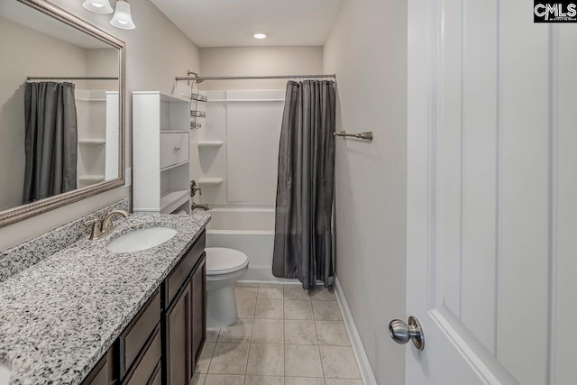 full bathroom with vanity, toilet, shower / bath combo with shower curtain, and tile patterned flooring