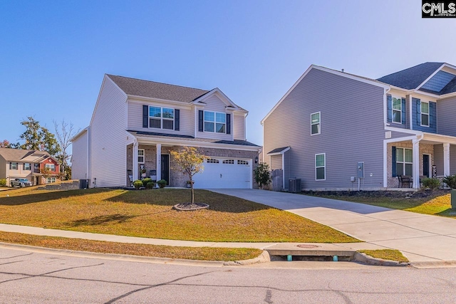 view of front of home with cooling unit, a front yard, and a garage