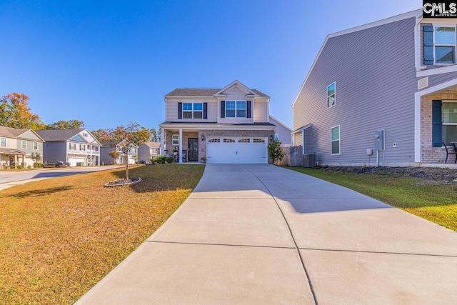 view of front of home with a front yard, central AC, and a garage