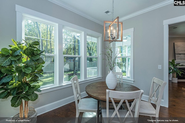 dining area with a notable chandelier, ornamental molding, and dark hardwood / wood-style floors