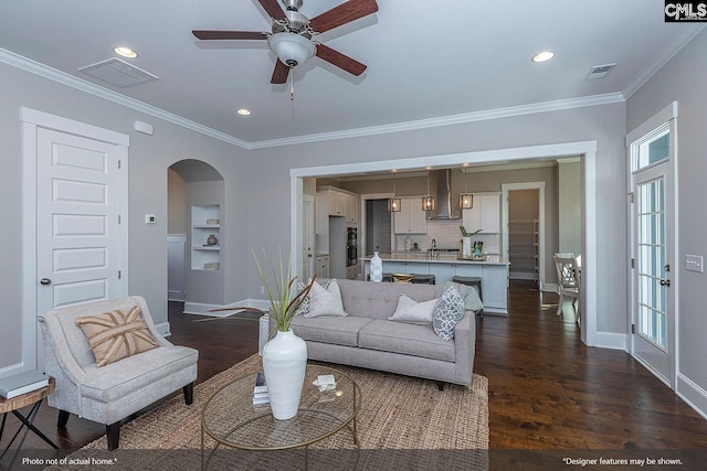 living room featuring ornamental molding, dark hardwood / wood-style floors, and ceiling fan