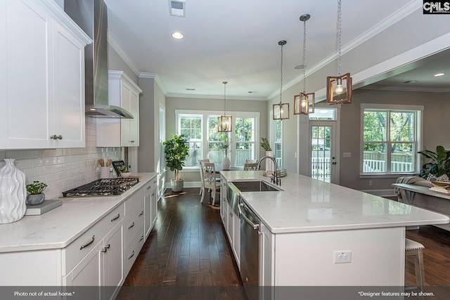 kitchen with white cabinets, hanging light fixtures, an island with sink, appliances with stainless steel finishes, and dark hardwood / wood-style flooring