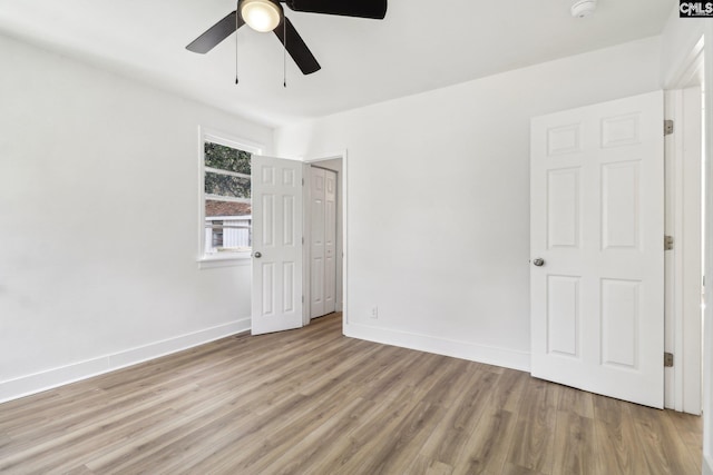 spare room featuring ceiling fan and light hardwood / wood-style flooring