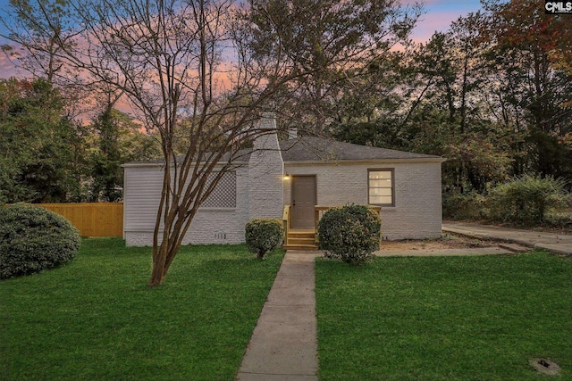 view of front of property with a lawn