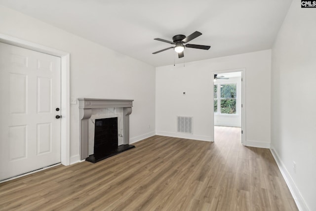 unfurnished living room with ceiling fan and wood-type flooring