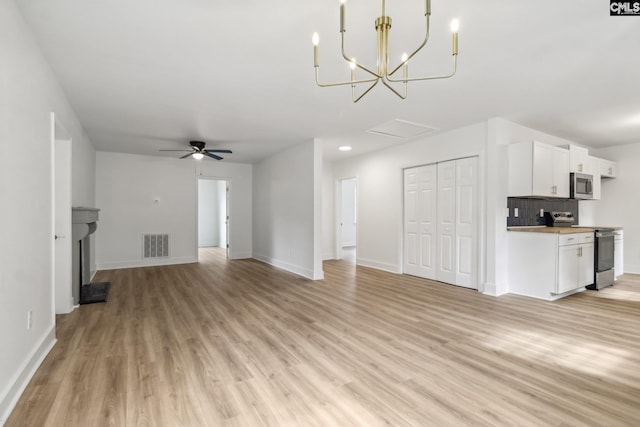 unfurnished living room with light hardwood / wood-style flooring and ceiling fan