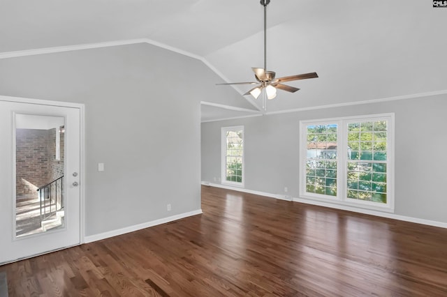 spare room with dark wood-type flooring, vaulted ceiling, and ceiling fan